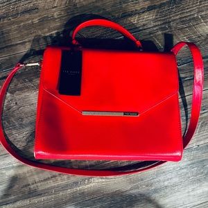 Brand new Ted Baker large tote. It’s never been used. Red with gold features.
